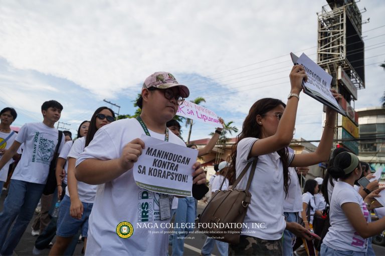 NCeans holding handheld placards with a statement denouncing corruption