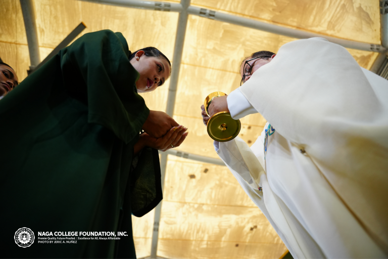 A graduand receiving the Communion wafer