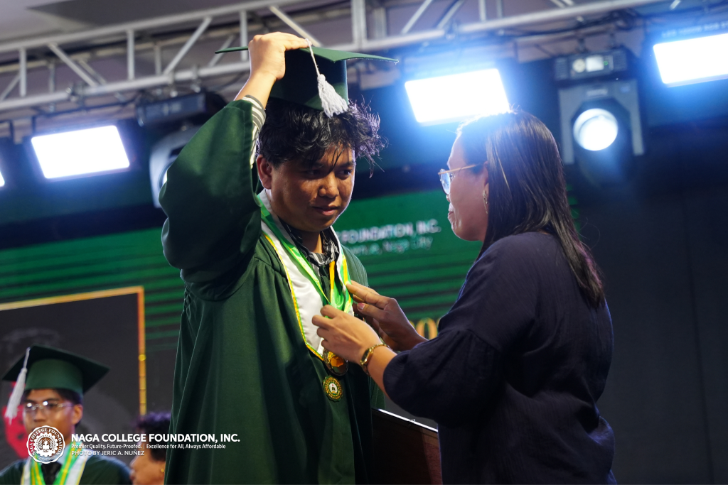A graduand of Computer Science with his parent during the culmination ceremony