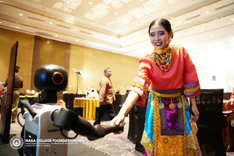 Tiger Humanoid Robot making handshake to a participant in ASEAN costume